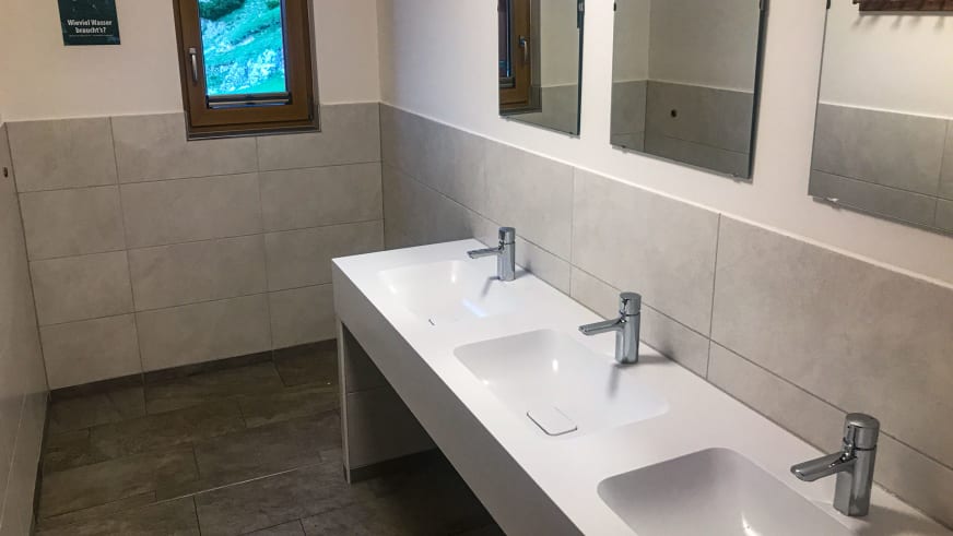 Sanitärbereich im Stöhrhaus mit drei modernen Waschbecken und Fliesenausstattung für Berghütten-Gäste.