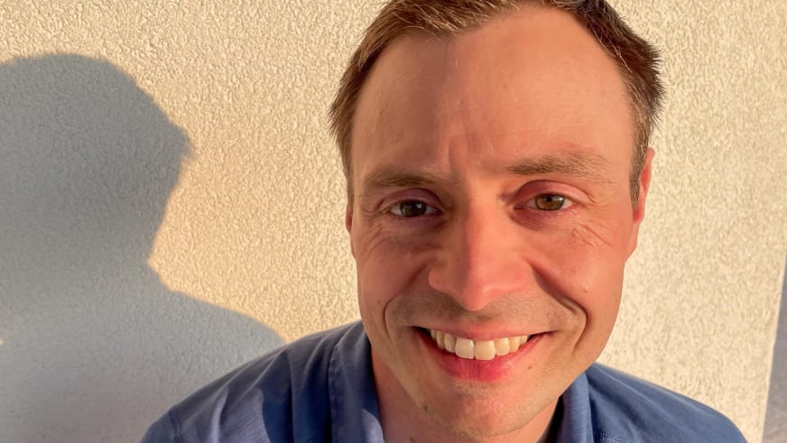 Portrait von Bergwanderführer Markus Radinger mit kurzen braunen Haaren und freundlichem Lächeln in blauem T-Shirt.