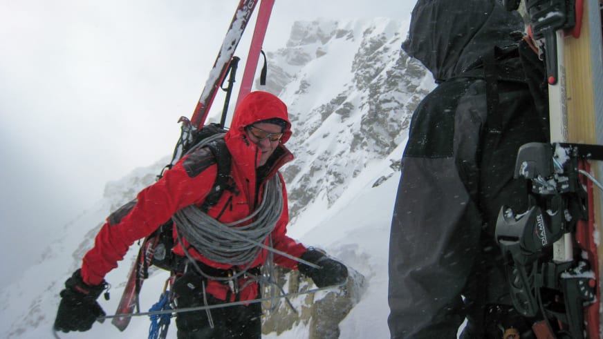 Bei der Skihochtour arbeitet Bergführer Franz Hölzl in roter Winterausrüstung mit Seilen und alpinen Geräten im Schnee.