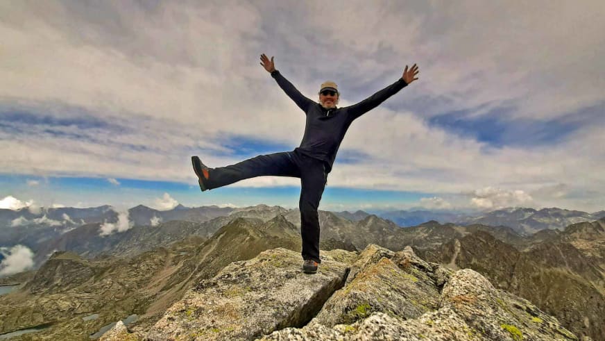 Auf Felsgipfel in den Picos de Europa macht Bergwanderführer Nacho Carreras Codina eine Siegerpose mit erhobenen Armen.