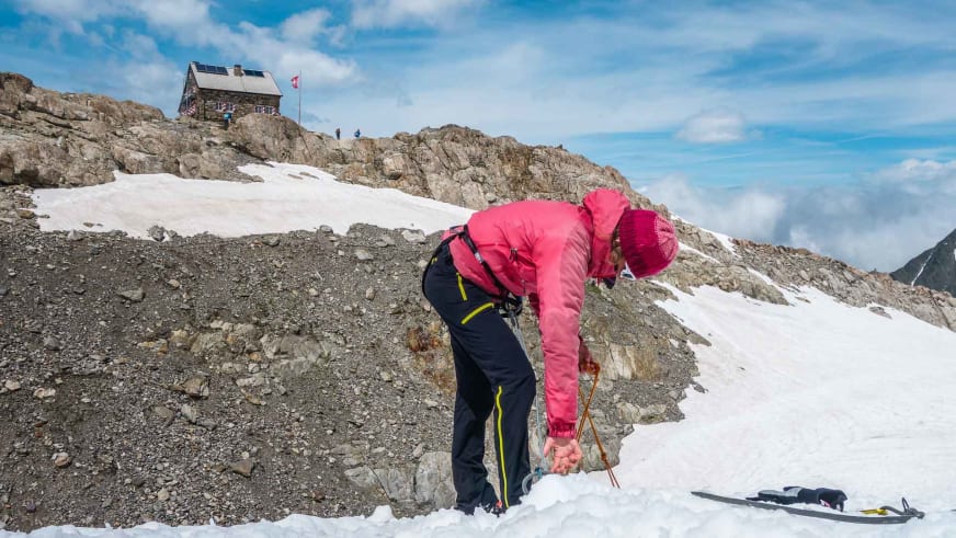 Bergführer übt Seilarbeit im Firnfeld vor der winterlichen Tierberglihütte während eines Gletscherkurses.