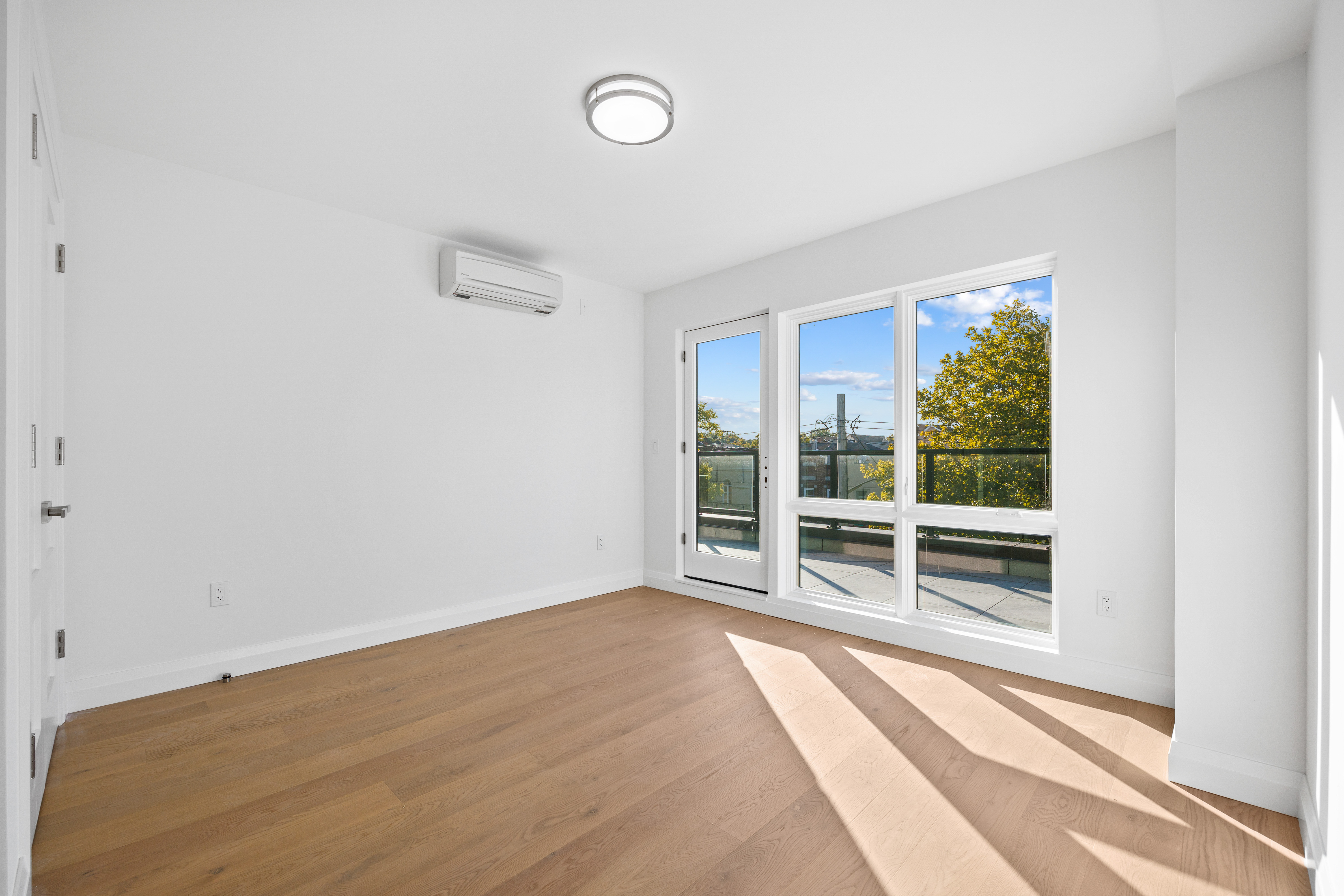 Bedroom with balcony access and city views