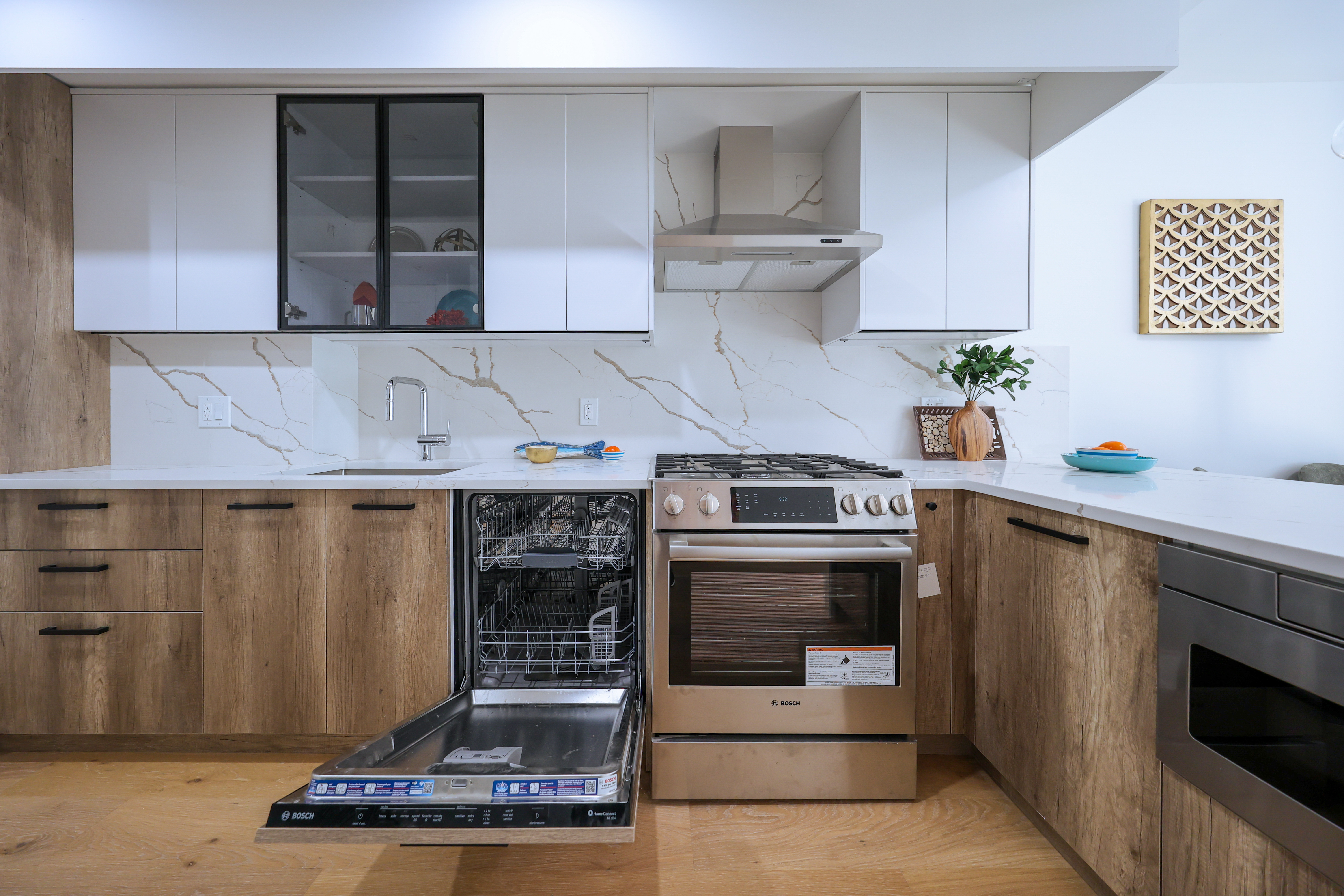 Modern kitchen with light wood cabinets and Caesarstone countertops