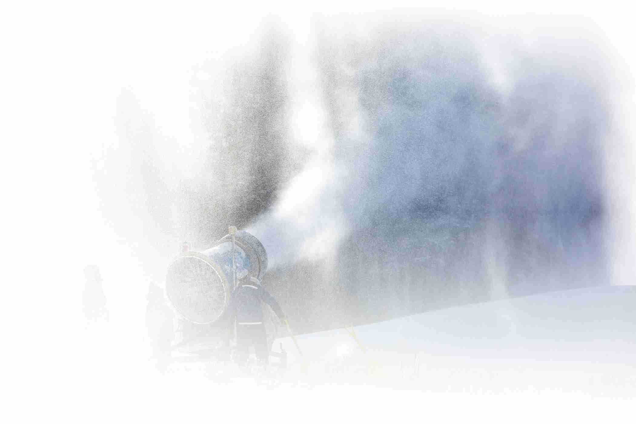 Snowmakers busy at work making snow on a cold and sunny October day at Alta Ski Area