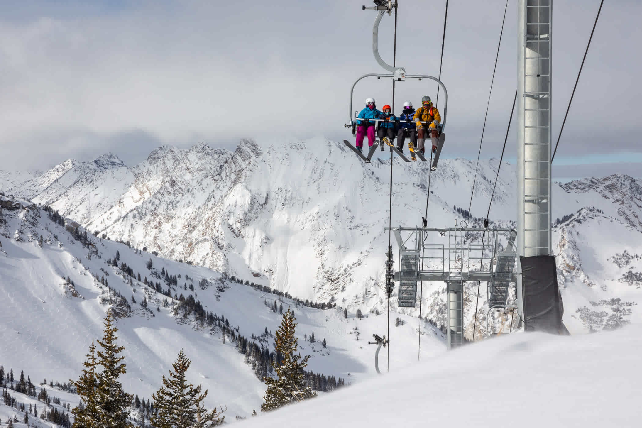 A family of Alta skiers ride the Supreme lift in December 2020