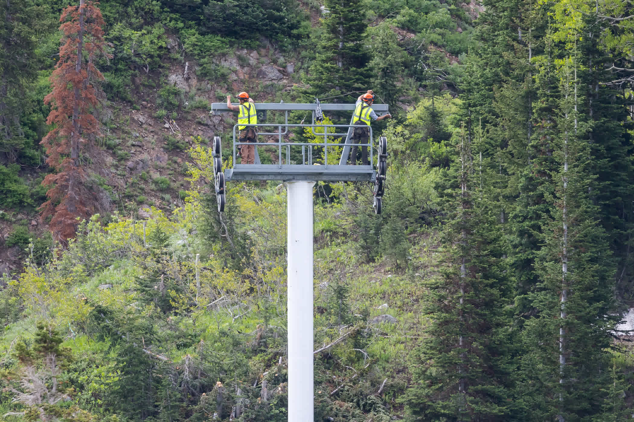 Left crew works to prep a Sunnysde lift tower for removal