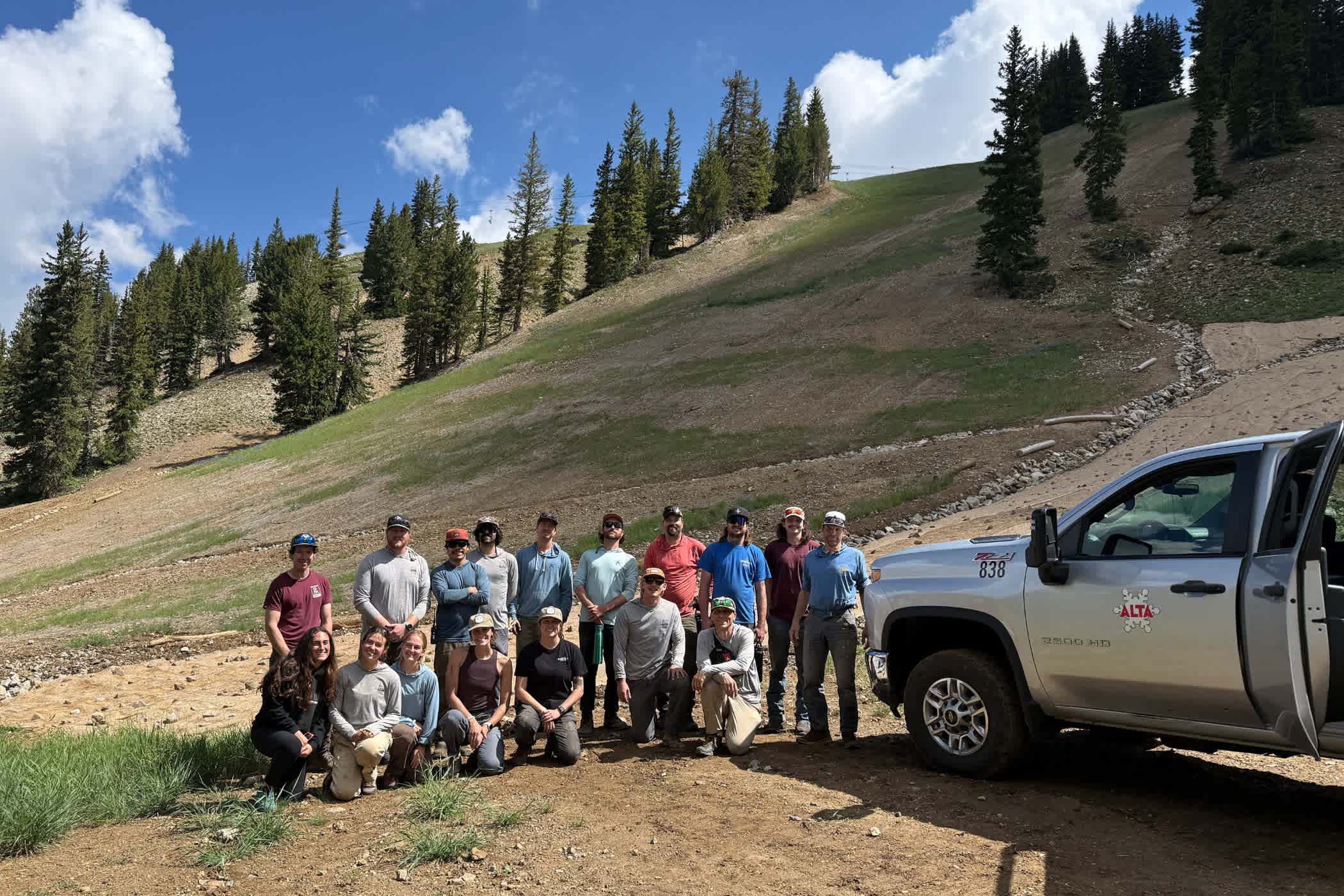 Alta employees gather for a portrait on a ski slope