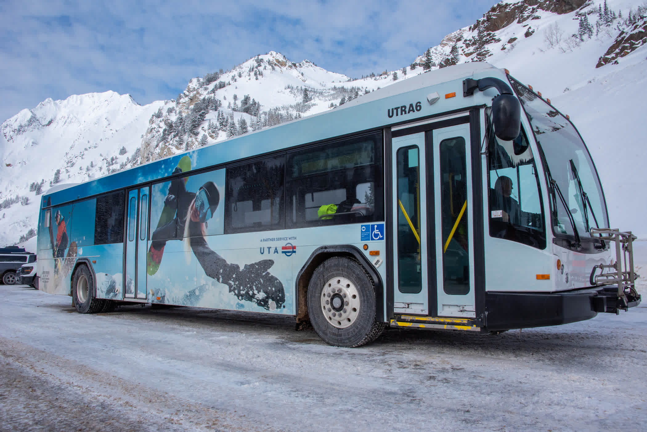 A public transportation ski bus drives down a snowy road