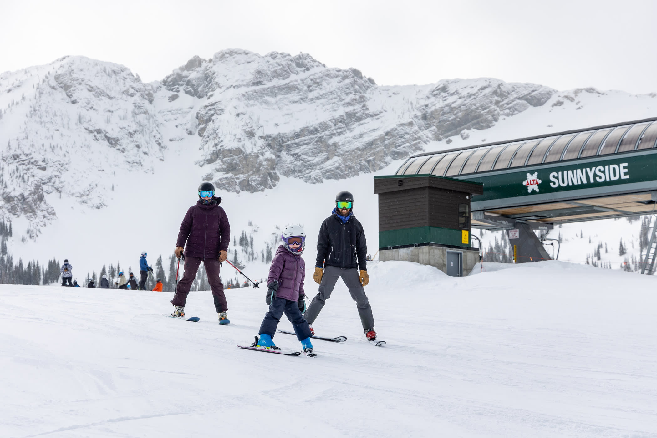 Parents ski with their young skier