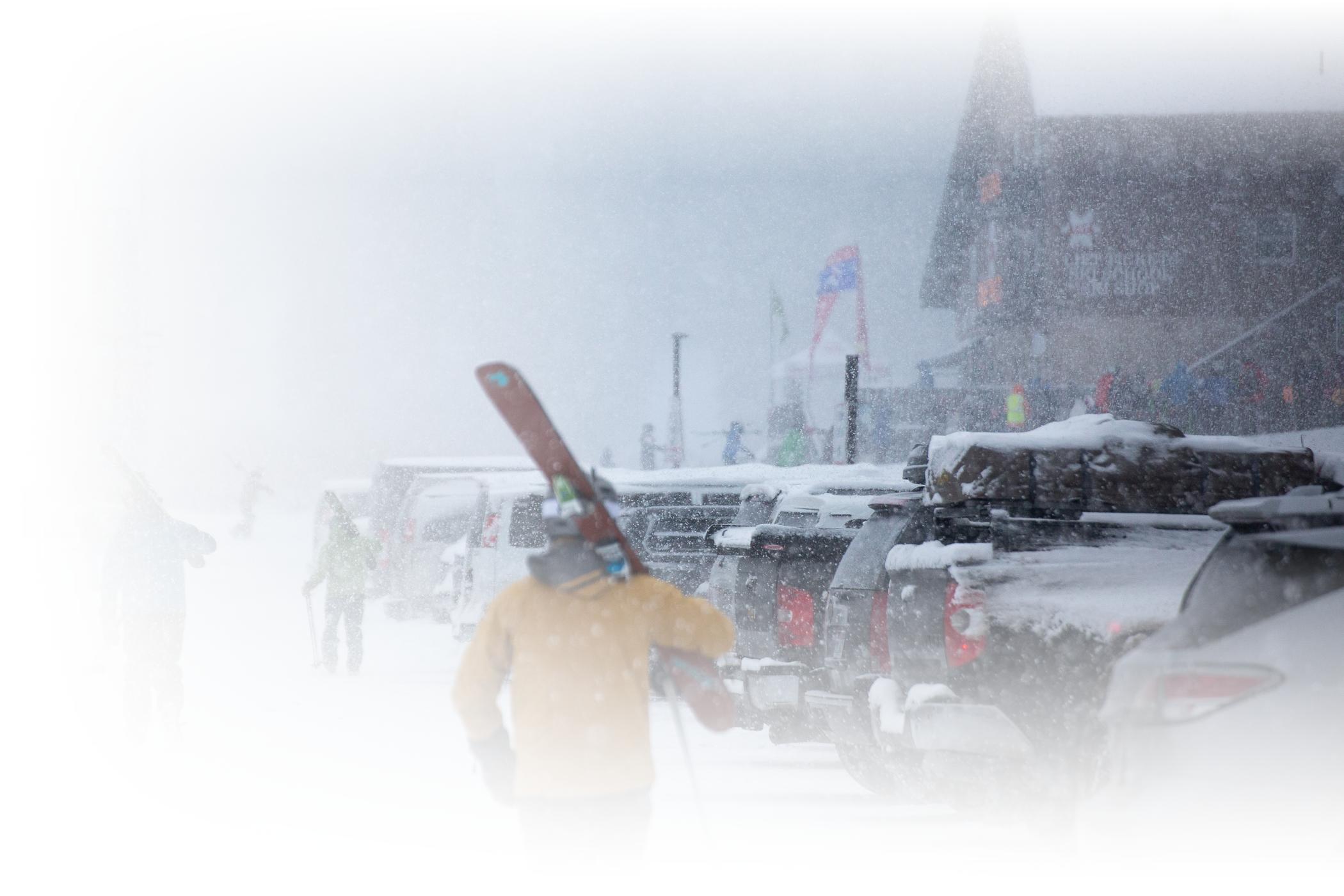Skiers walking through the Wildcat parking lot in the Wildcat base.