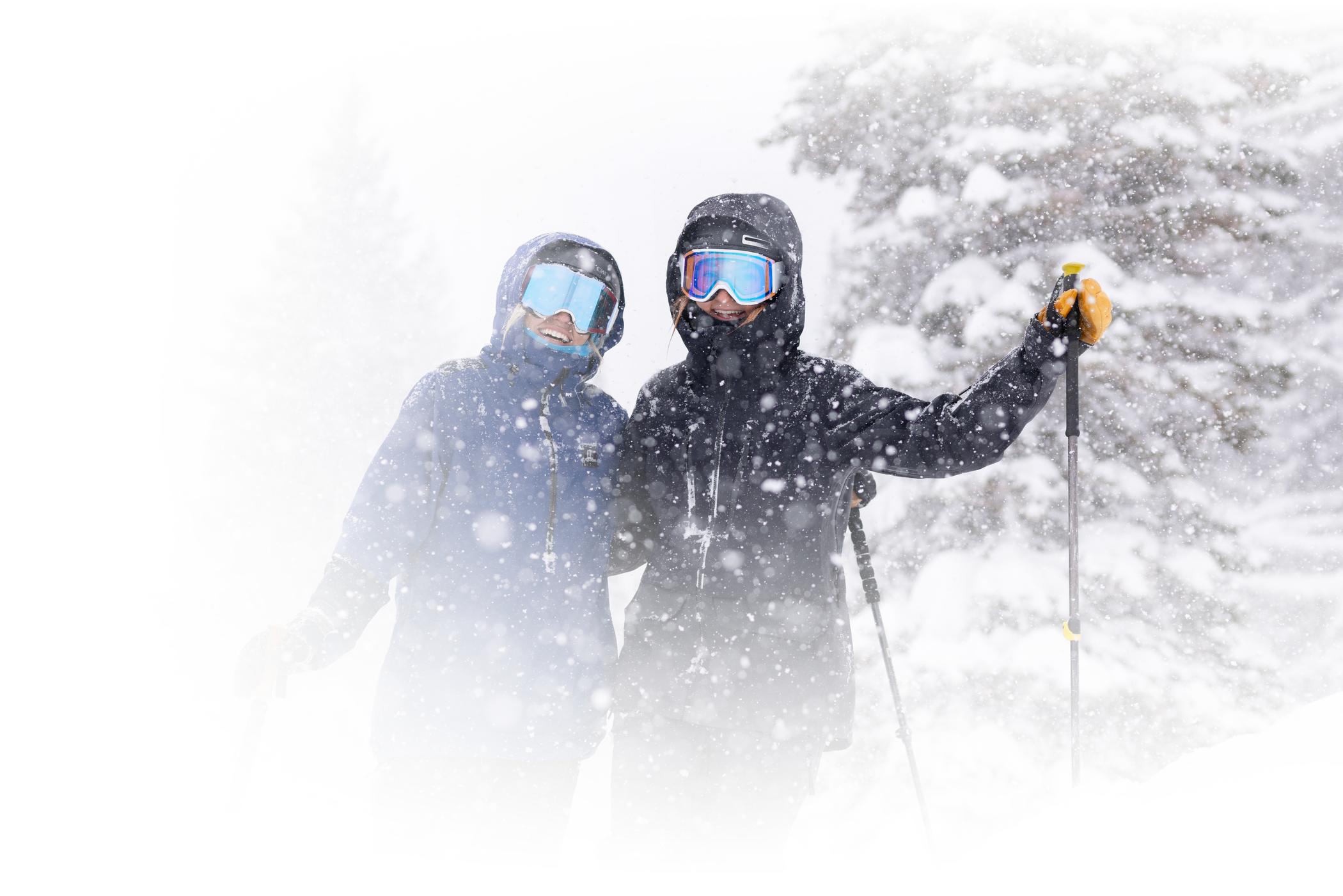 Two stoked skiers smile on a snowy day at Alta Ski Area