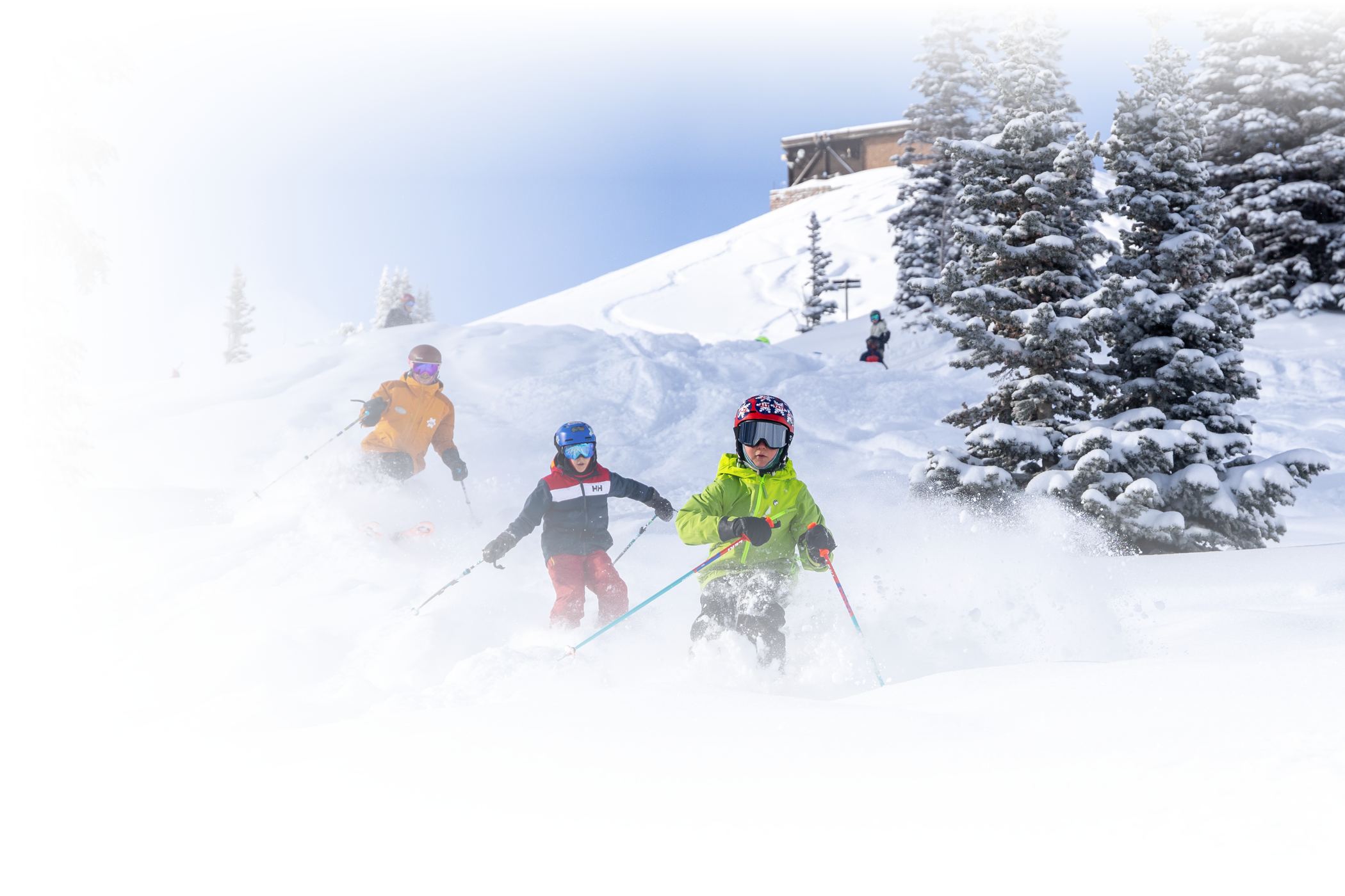 group of skier kids posing with a ski instructor in front of mountain