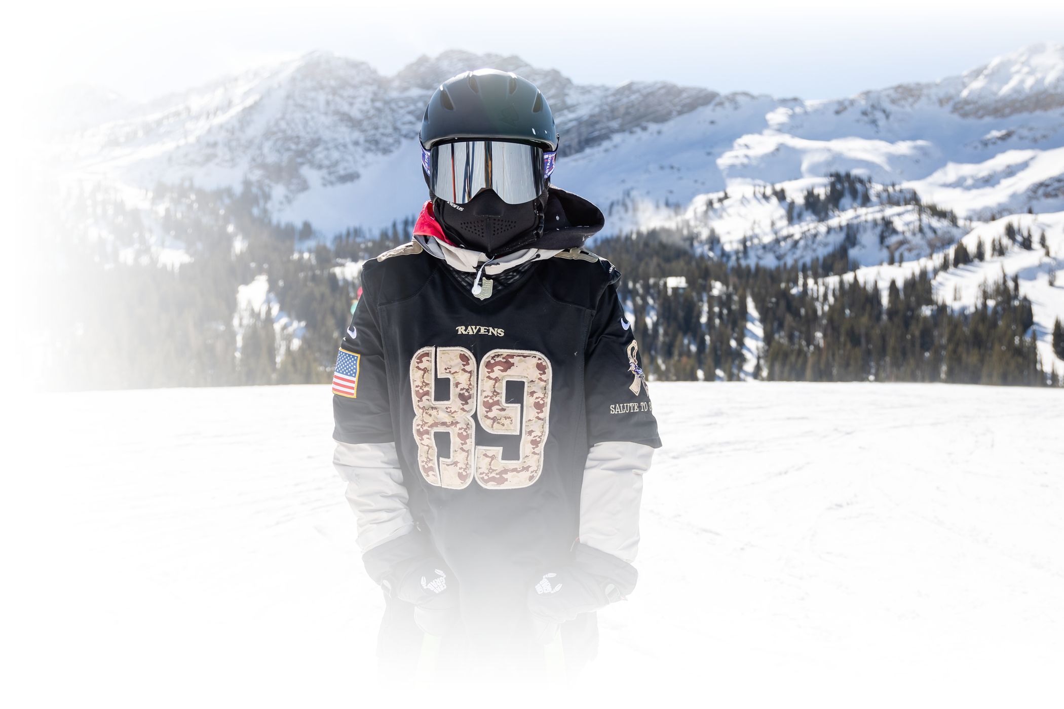 A young skier in a football jersey
