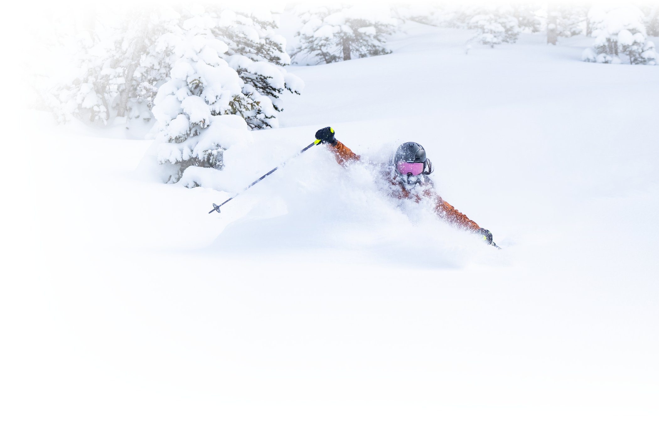 A female skier enjoys deep powder at Alta Ski Area