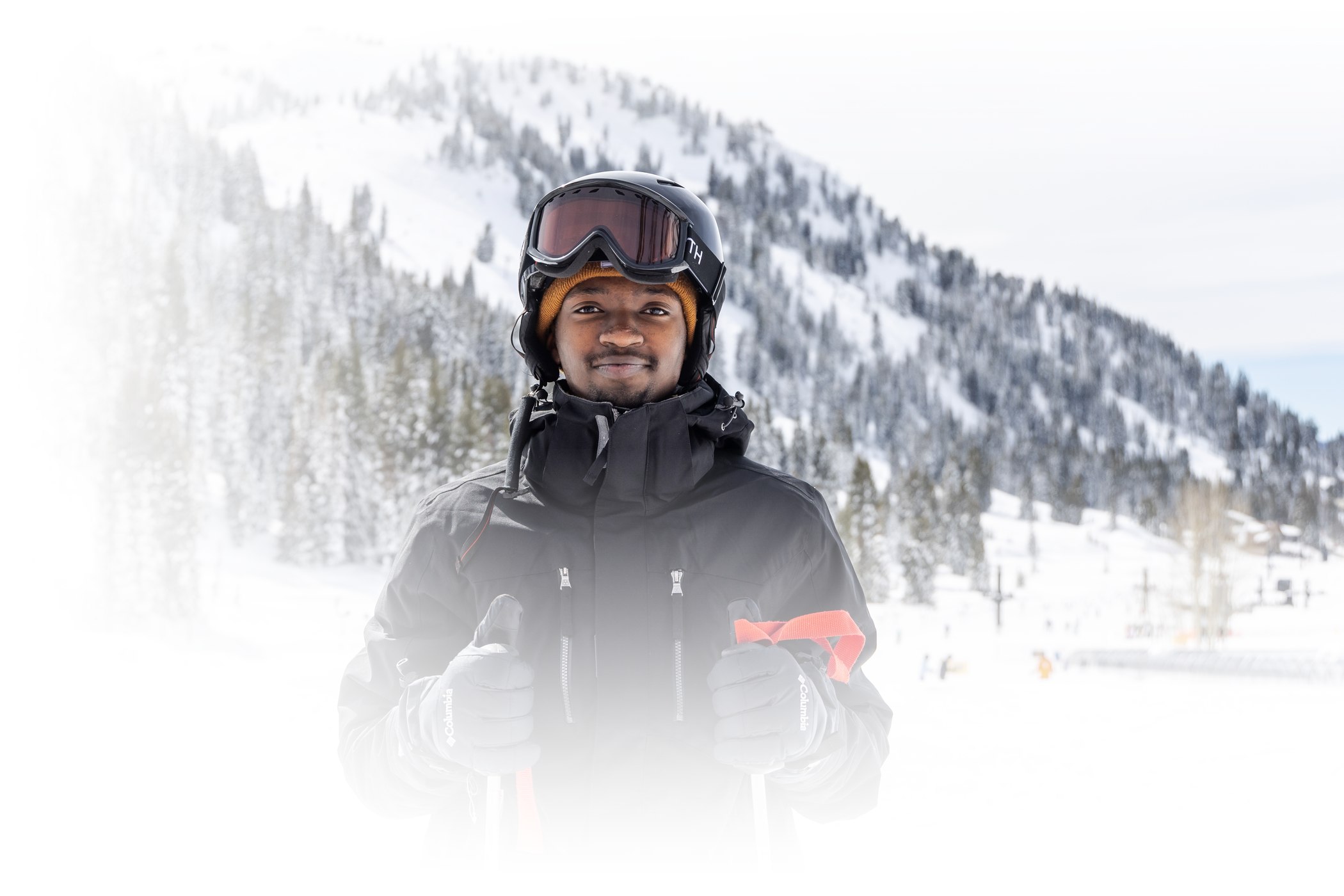 A skier smiles on a sunny February day at Alta Ski Area