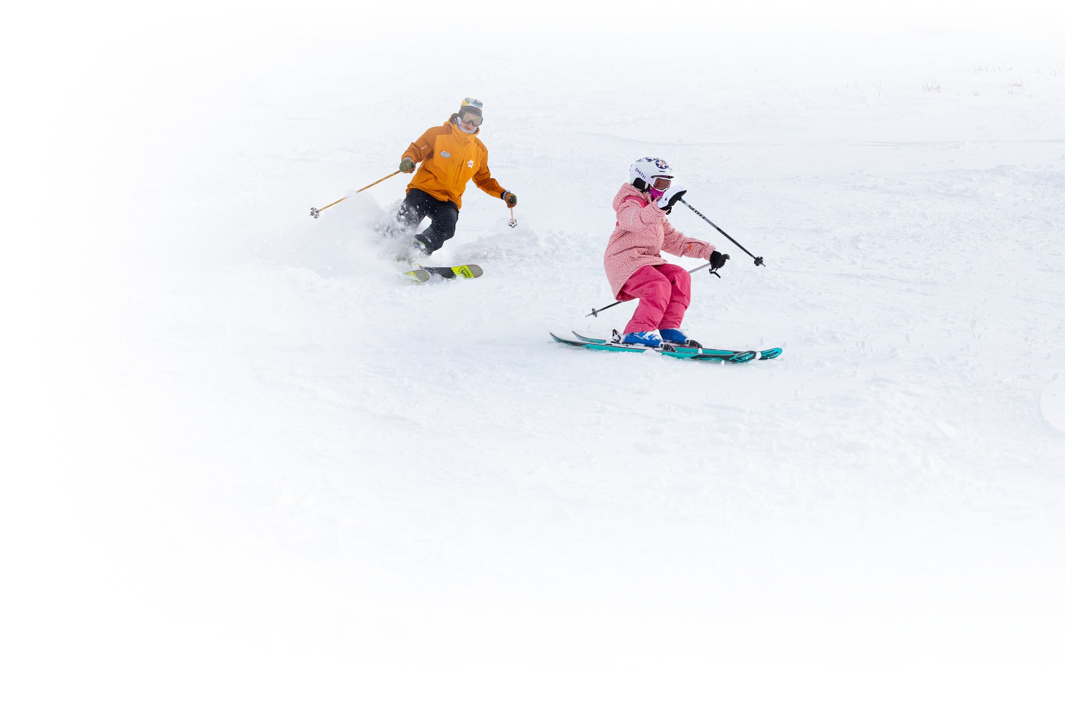 ski instructor instructing a young child