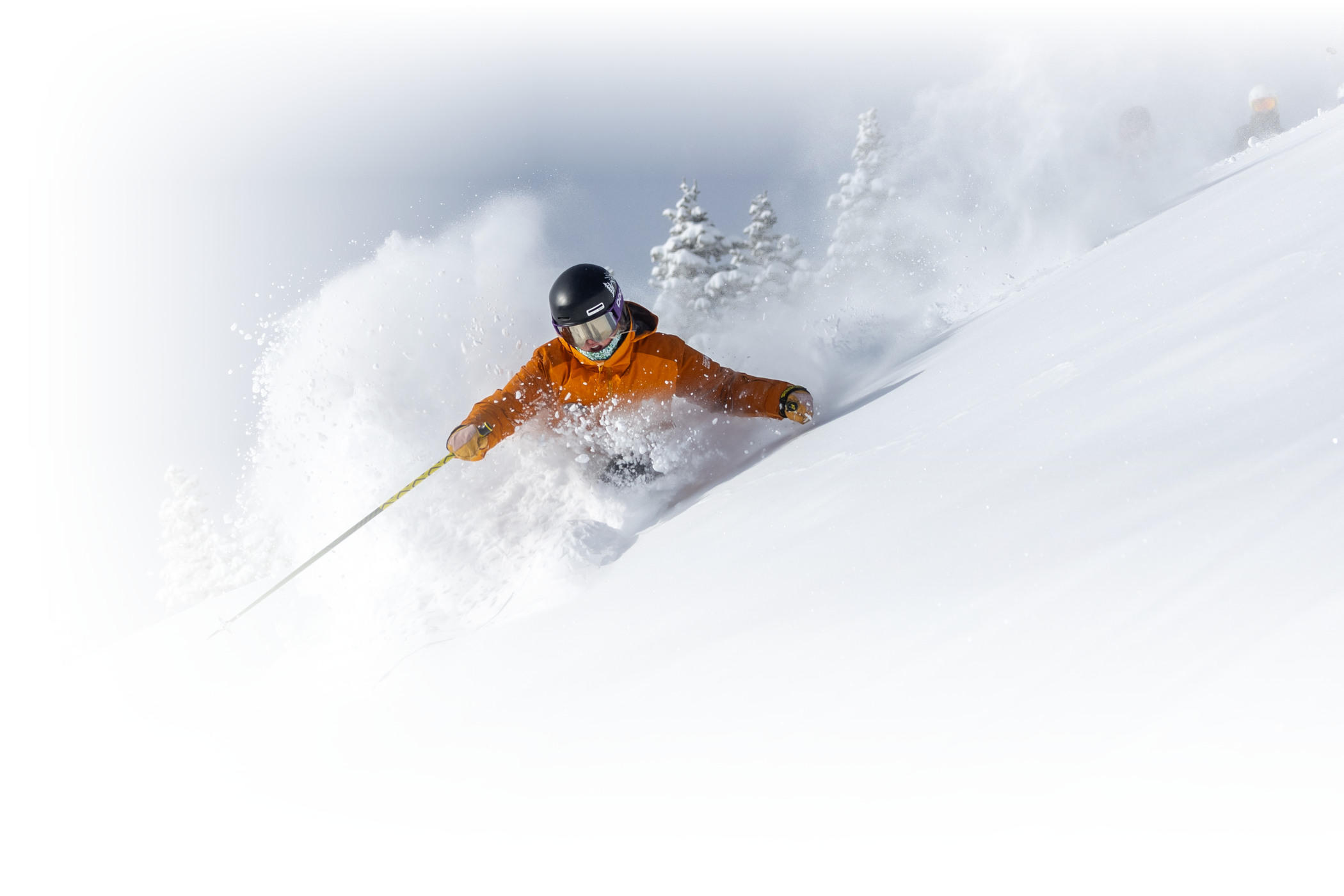 An Alf Engen Ski instructor skis powder on a bluebird powder day at Alta Ski Area