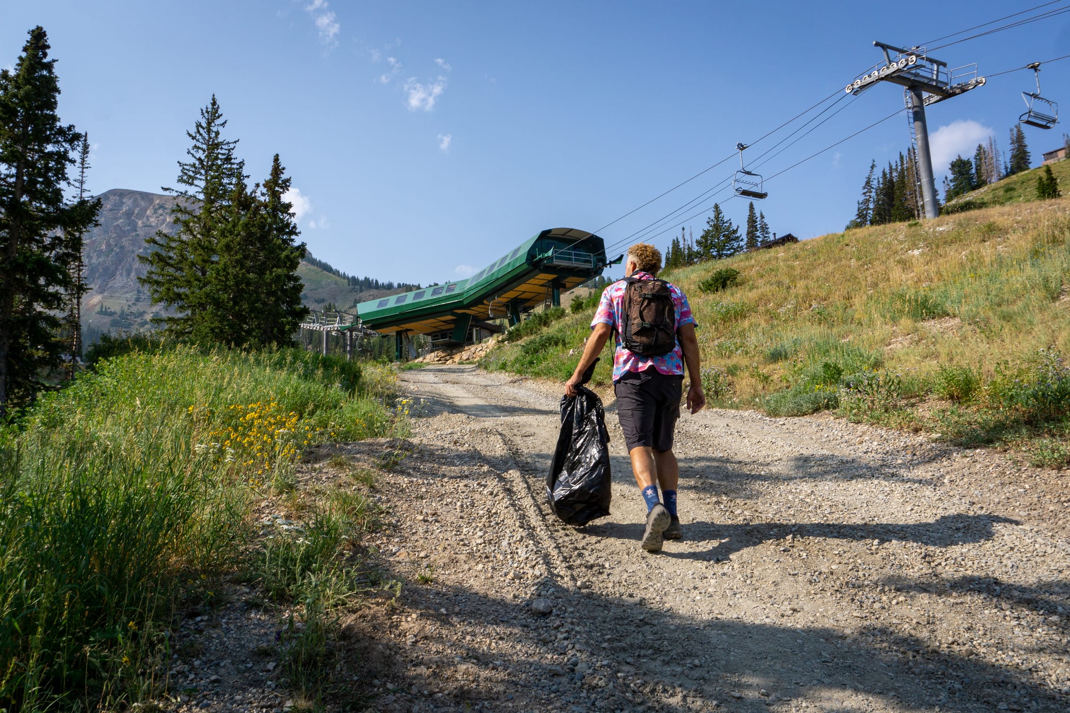 Volunteers hike up the mountain, looking for trash