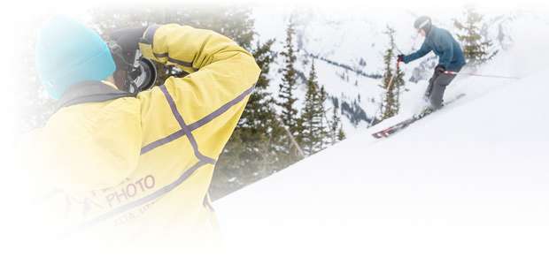 Peak Photographer taking a photo of a skier