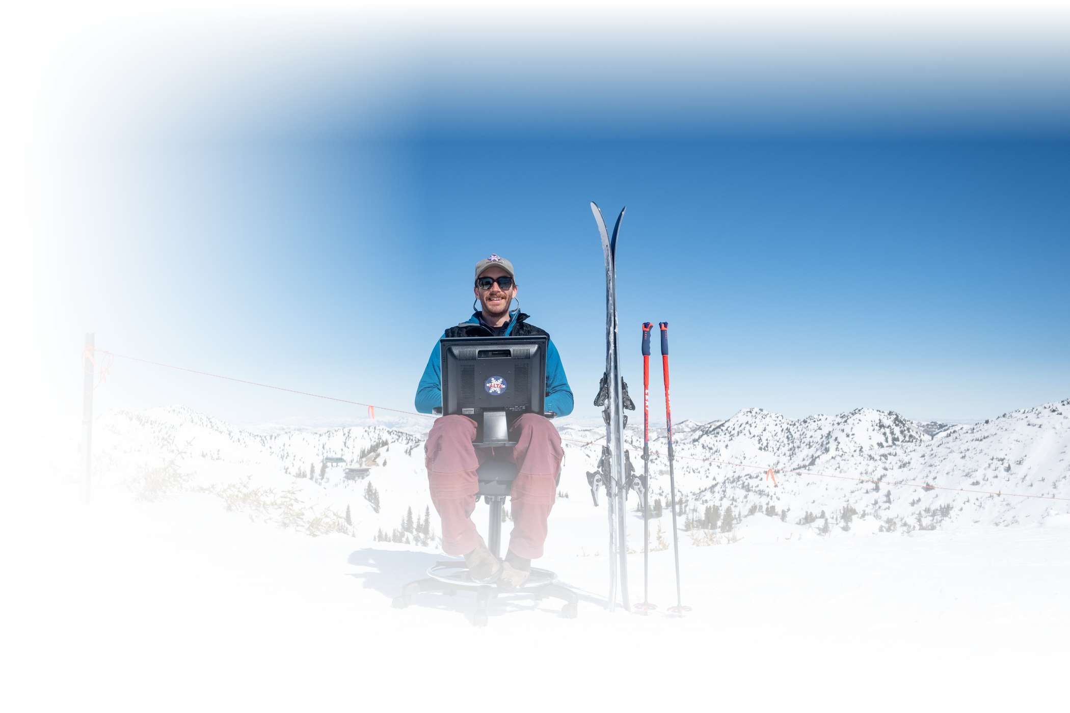 An Alta employee smiles behind his workstation at the top of the mountain