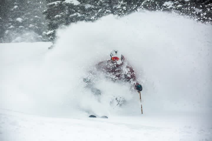 Adam Fehr comes up for air skiing deep powder
