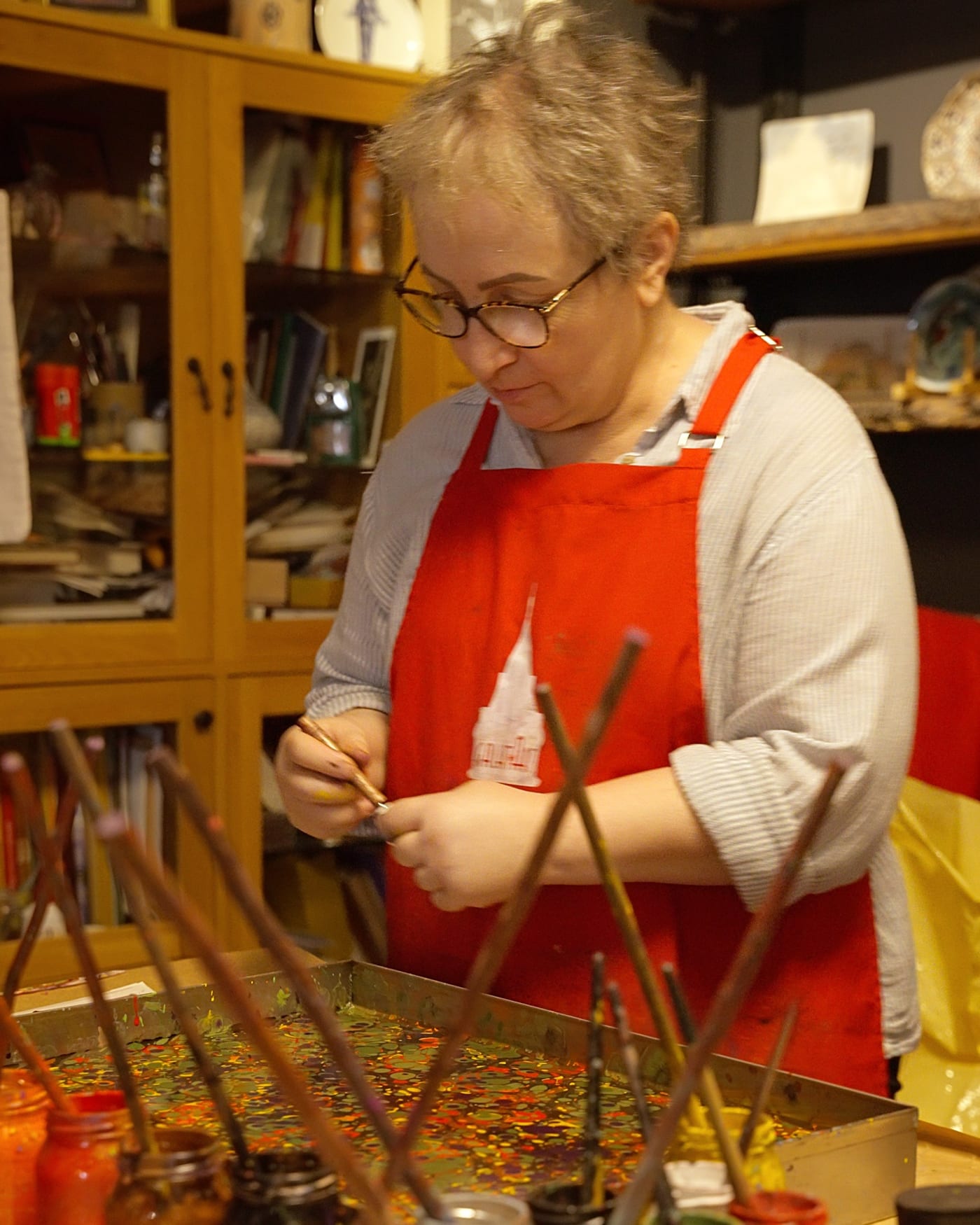 Nesime Kantar at her tray in the Galata atelier, stylus in hand