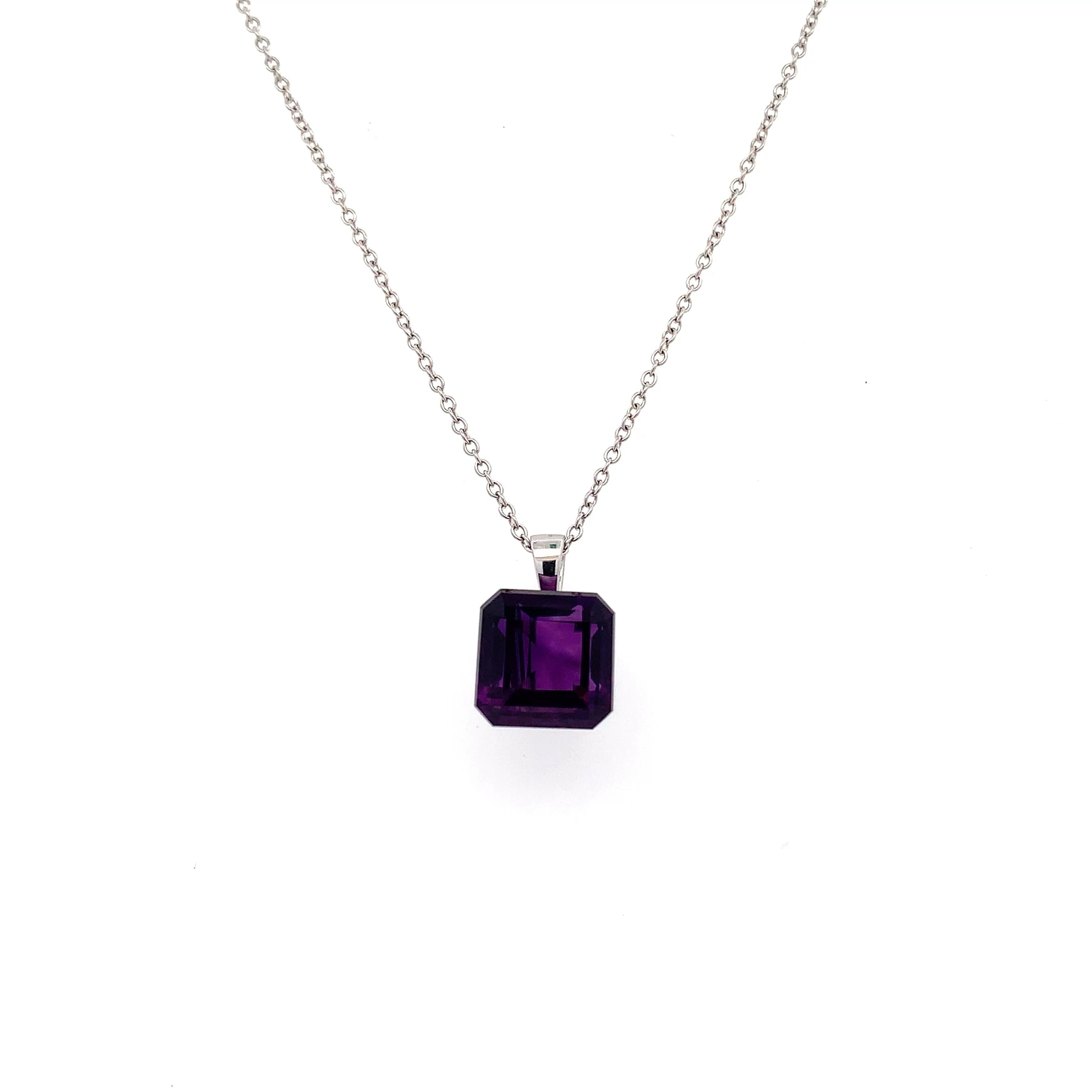 Amethyst purple pendant necklace 18k pendant necklace 18k white gold. This amethyst purple pendant necklace 18k emerlad square cut 5.80ct gemstone pendant is the perfect accessory for any occasion. Crafted with precision, the vibrant hue of the stone measures approximately 11mm catches the light beautifully, making it a standout piece. Whether you're dressing up for a night out or adding a touch of elegance to your everyday look, this pendant is sure to impress. Chain 16 inches 18k white gold. Accompanied by valuation This stunning amethyst 5.80ct pendant necklace features a beautifully cut square gemstone that radiates elegance. The rich purple hue of the amethyst measuring 11mm is complemented by a delicate 18k gold chain, making it a perfect accessory for any occasion. Whether you're dressing up for a night out or adding a touch of sophistication to your everyday look, this pendant is sure to turn heads. Accompanied by valuation