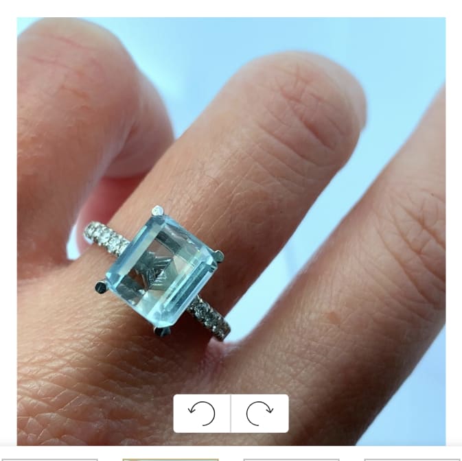 This stunning blue aquamarine emerald cut 1.65ct ring features a captivating rectangular stone, surrounded by hidden diamond halo 0.70ct F VS1 a delicate band adorned with sparkling accents. Perfect for special occasions or as a statement piece, it embodies elegance and sophistication. Accompanied by valuation
