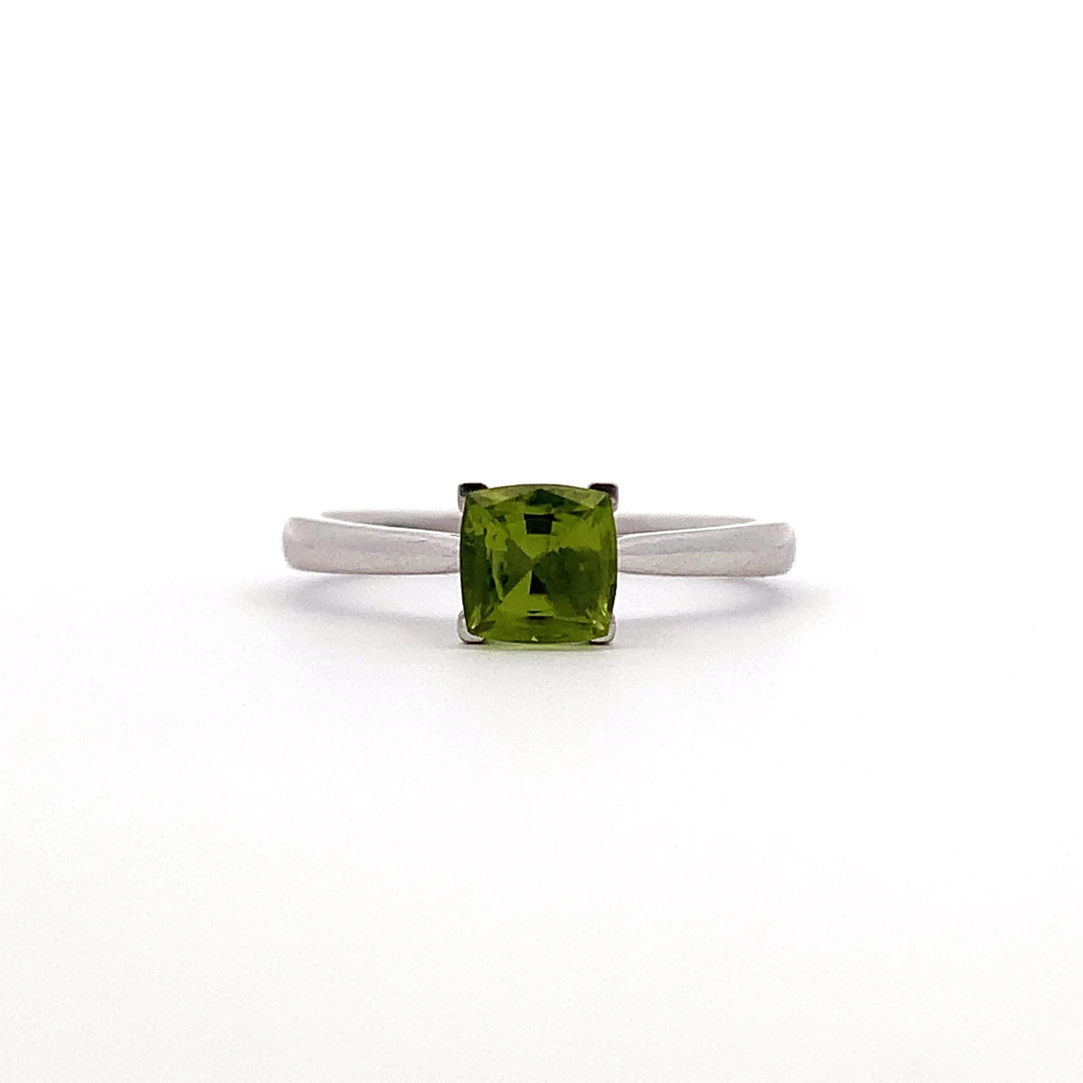 Discover the beauty of this elegant green peridot 0.68ct gemstone ring, featuring a stunning square-cut peridot stone that captures the light beautifully. The sleek band is 18k white gold complements the vibrant hue, making it a perfect accessory for any occasion. Whether you're dressing up for a special event or adding a touch of sophistication to your everyday look, this ring is sure to turn heads. Accompanied by valuation