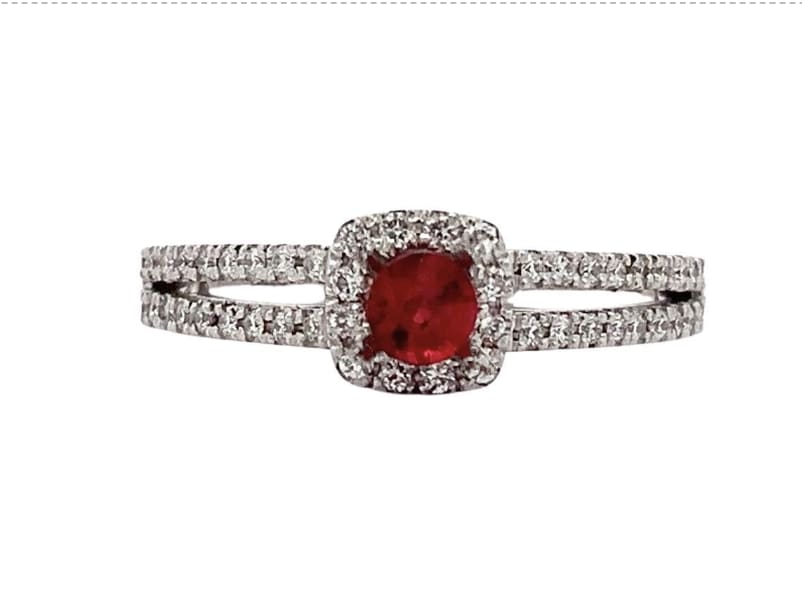 Discover the timeless beauty of this elegant Ruby and diamond ring. Featuring a stunning central red round cut Ruby gemstone surrounded by a halo of sparkling diamonds