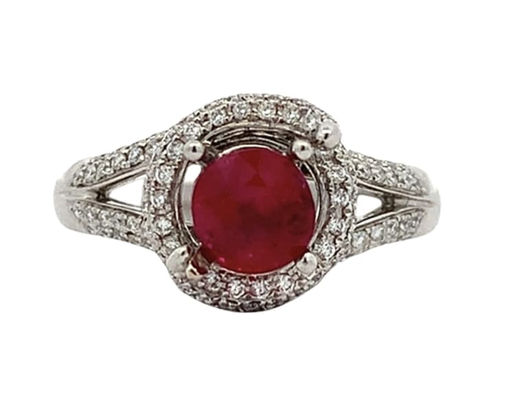 Discover the allure of this stunning ruby and diamond twisted halo ring, featuring a vibrant red Ruby round cut gemstone that captures the essence of elegance.