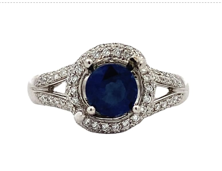Discover the allure of this stunning ruby and diamond twisted halo ring, featuring a vibrant red Ruby round cut gemstone that captures the essence of elegance.