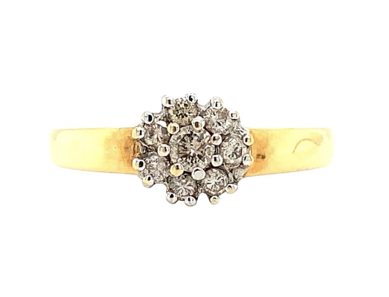 This stunning 18ct yellow gold ring features a beautiful round-cut diamond set in a cluster style, perfect for engagements and special occasions.