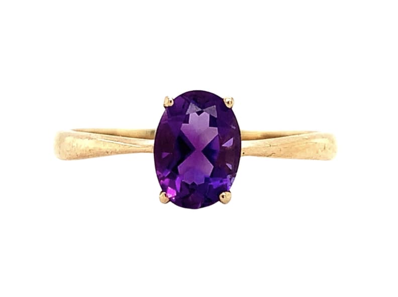 This beautiful ring features a stunning oval-shaped amethyst as the main stone, which has a natural creation and excellent cut grade. The amethyst is set in a classic solitaire setting on a 9ct yellow gold band with a width of 2mm. The ring is perfect for engagement and special occasions, and the purple colour of the amethyst adds to its beauty. The ring is customisable, and it comes in a ring size of M.