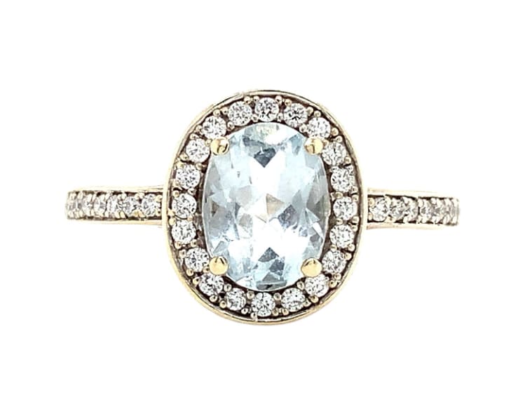 This stunning engagement ring is the perfect choice for any couple looking to make a statement. Crafted in 9k white gold, it features a beautiful blue sky aquamarine and diamond halo setting that surrounds the main stone, aquamarine weighing approximately 1.30ct and diamonds 0.25ct F VS2. Additionally, the ring is adorned with sparkling diamonds, making it a true symbol of love and elegance. Aquamarine head measuring approximately 11x10mm, band width 2mm. Handcrafted in London. Accompanied by valuation. Ideal for any special occasion, this ring is a must-have for anyone who wants to show their loved one just how much they care. With its unique design and exquisite attention to detail, it is sure to make a lasting impression. So why wait? Treat yourself or your partner to this beautiful piece of jewellery today and make your love shine. Gorgeous light blue aquamarine gemstone surrounded by diamond sparkling halo antique style art deco ring.