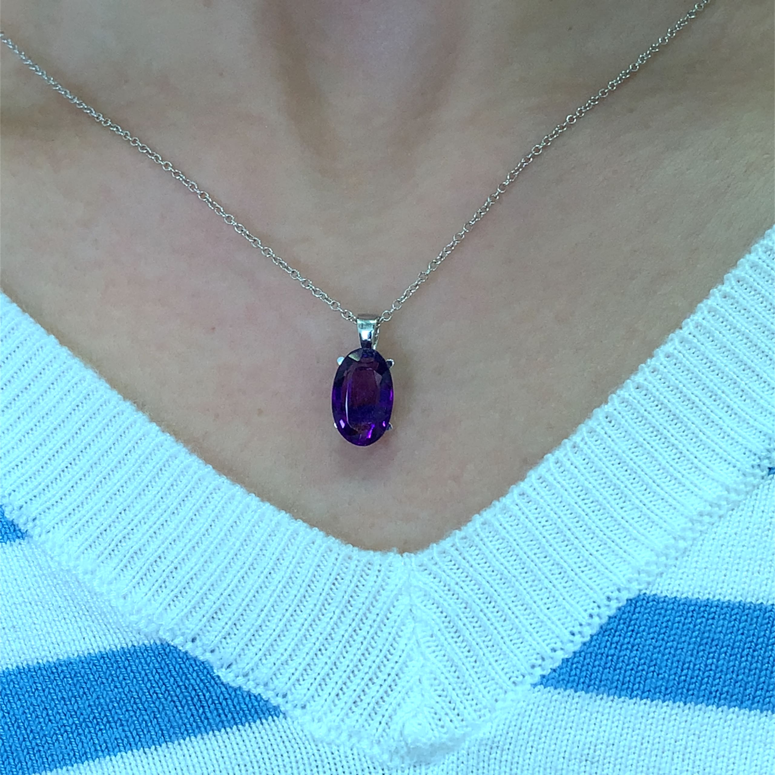 Amethyst purple pendant necklace 18k pendant necklace 18k white gold. This amethyst purple pendant necklace 18k elongated oval cut 3.40ct gemstone pendant is the perfect accessory for any occasion. Crafted with precision, the vibrant hue of the stone measures approximately 13/8mm catches the light beautifully, making it a standout piece. Whether you're dressing up for a night out or adding a touch of elegance to your everyday look, this pendant is sure to impress. Chain 16 inches 18k white gold. Accompanied by valuation This stunning amethyst 3.40ct pendant necklace features a beautifully cut oval shaped gemstone that radiates elegance. The rich purple hue of the amethyst measuring 13/8mm is complemented by a delicate 18k gold chain, making it a perfect accessory for any occasion. Whether you're dressing up for a night out or adding a touch of sophistication to your everyday look, this pendant is sure to turn heads. Accompanied by valuation
