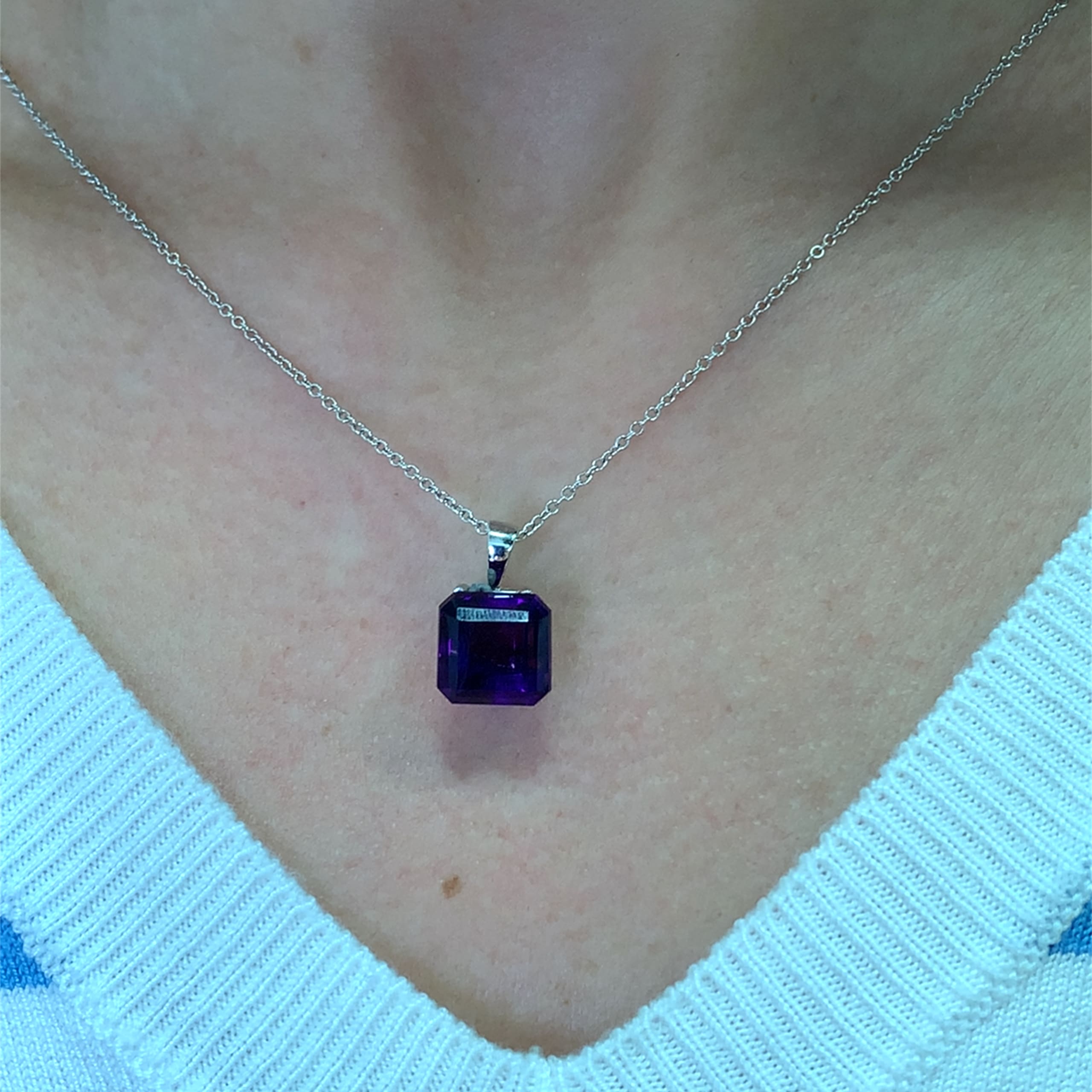 Amethyst purple pendant necklace 18k  pendant necklace 18k white gold. This amethyst purple pendant necklace 18k emerlad square cut 5.80ct gemstone pendant is the perfect accessory for any occasion. Crafted with precision, the vibrant hue of the stone measures approximately 11mm catches the light beautifully, making it a standout piece. Whether you're dressing up for a night out or adding a touch of elegance to your everyday look, this pendant is sure to impress. Chain 16 inches 18k white gold. Accompanied by valuation This stunning amethyst 5.80ct pendant necklace features a beautifully cut square gemstone that radiates elegance. The rich purple hue of the amethyst measuring 11mm is complemented by a delicate 18k gold chain, making it a perfect accessory for any occasion. Whether you're dressing up for a night out or adding a touch of sophistication to your everyday look, this pendant is sure to turn heads. Accompanied by valuation
