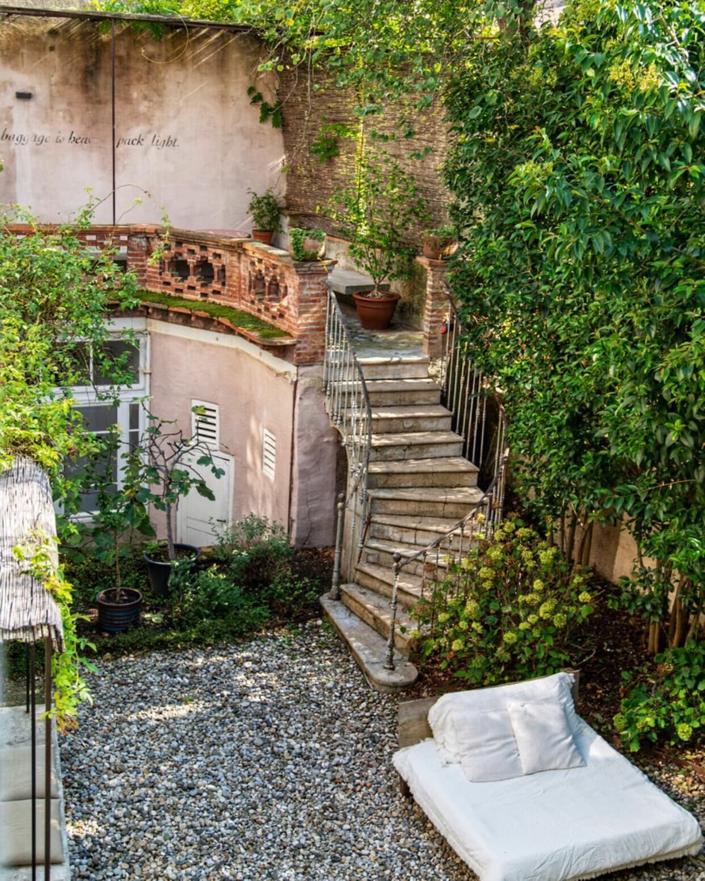 Camellas Lloret — garden courtyard and stone stairs