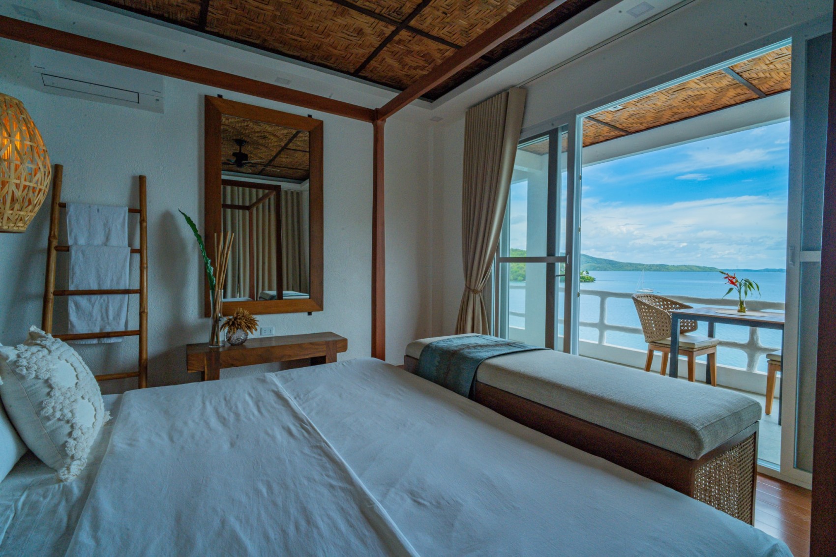 Oceanfront suite bedroom with balcony and sea view