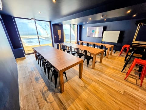 Salle de séminaire en configuration classe avec tableau blanc et écran