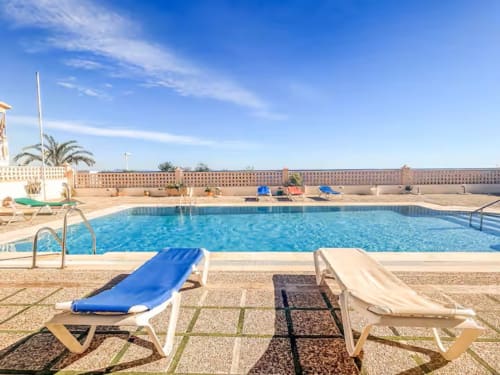 Swimming pool with blue loungers at Apartamentos El Calón Playa, Cuevas del Almanzora, Spain