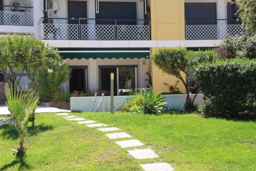 Seahorse House garden with lawn pathway, Mediterranean plants, and furnished terrace at Break Lovers Tavira