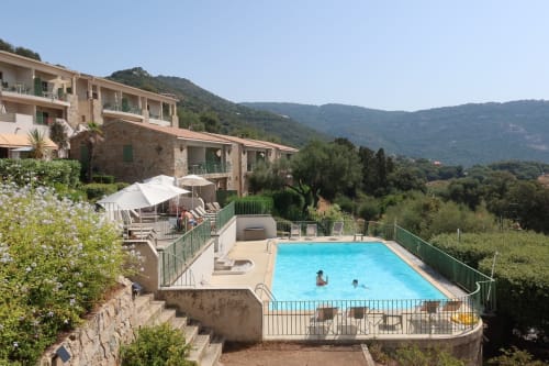 Résidence Roc E Mare pool with sea views, Cargèse Corsica - guests swimming in resort pool