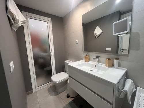 Modern bathroom with sink, toilet, shower in Corralejo Sol y Sal apartment at FTV Holidays Homes