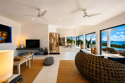 Spacious open-plan living area at Indigo Villa Samui with sea views, ceiling fans, woven furnishings, and modern amenities