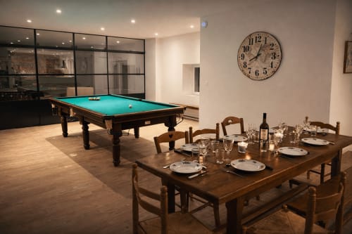 Le Bovary villa entertainment room with dining table, pool table, and clock at Les Gites De Flaubert