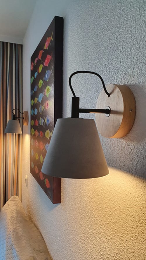 Modern wall sconce with wooden backplate and gray cone shade in Ô CAP COZ bedroom at Location Vacances Finistère Sud, La