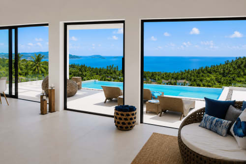 Luxury villa in Ko Samui with ocean view, infinity pool, modern furniture, and tropical landscape overlooking blue sea