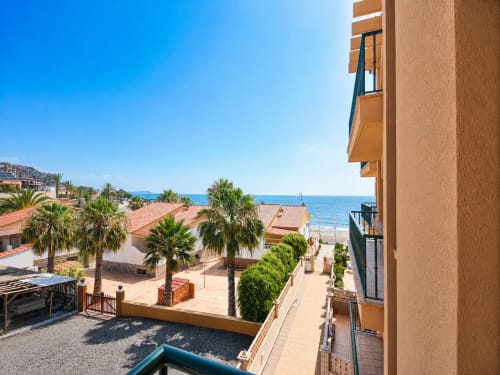 Beachfront apartment view in Cuevas del Almanzora with sea views, palm trees, and Mediterranean coastline