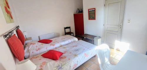 Bright Poppy room at Les Gites de Campardon with twin beds, red accents, and garden view in Montiers, France
